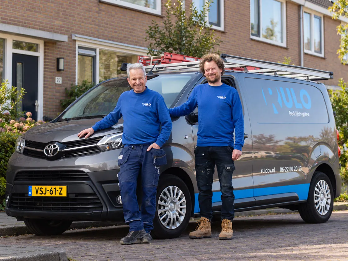 Twee medewerkers van RULO bij hun bedrijfsbus